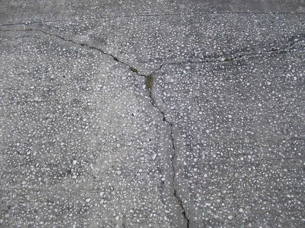 Representative cracked concrete driveway repair example for Pflugerville homeowners